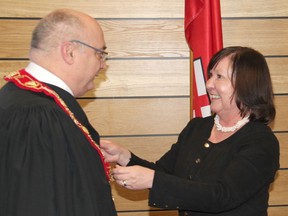 Bonnechere Valley Mayor Jennifer Murphy, who seconded the nomination of Renfrew Reeve Peter Emon, places the warden's chain of office around his neck as Emon was sworn in at the inaugual meeting of County of Renfrew Council last month. Anthony Dixon