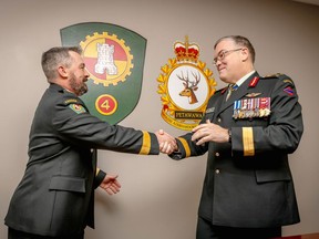 Commander of the Canadian Army, Lt.-Gen. Jocelyn Paul (right) congratulates Garrison Petawawa Commander Brig.-Gen. John Vass after promoting him to his current rank on Dec. 9. DND Photo
