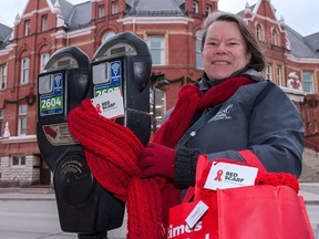 Stratford knitter Laurie Krempien-Hall and a group of local volunteers were decorating that city's downtown core with red scarves on World AIDS Day, Dec. 1. Chris Montanini/Postmedia