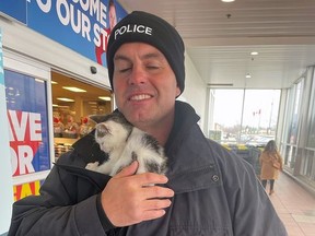 St. Thomas Police Const. Sean James cuddles a lost kitten found wandering a shopping centre parking lot during a Stuff the Cruiser event for charity.

Don Nicholson