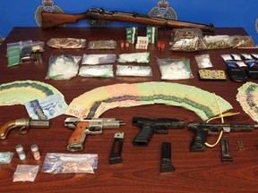 This photo of drugs, cash and weapons seized this week as part of a drug trafficking investigation was provided by Sarnia police.