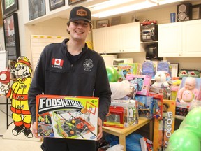 Firefighter Gavin Burgess stands with toys already donated for Point Edward Fire and Rescue's annual Santa's Responders toy drive.  Donated toys will be accepted until Dec. 12 at the village fire hall and delivered later this month to Bluewater Health and St. Clair Child and Youth Services.