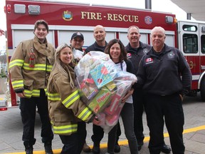Point Edward firefighters deliver donated toys Friday collected at the village fire hall for children being treated at Bluewater Health over the holidays. Toys were also collected for St. Clair Child and Youth Services. From left, Gavin Burgess, Justine Davies, Emilson Posadas, Claudo Palleschi, Kathy Alexander, executive director of the Bluewater Health Foundation, Deputy Chief Rick MacGregor and Fire Chief Doug MacKenzie.