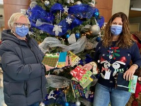 Carol Cote, left, holds a few of the more than 300 pillowcases she and her friends made this year for patient beds at Bluewater Health over the holidays.  With her is Rebecca Brander with the Bluewater Health Foundation.  Handout