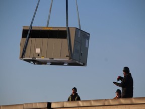 A new HVAC unit is lifted Thursday morning onto the roof of the Pathways Health Center for Children in Sarnia.  (PAUL MORDEN/The Observer)