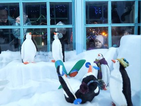 Children look through the window of a display at the Simcoe Panorama of Lights during the opening night on Saturday. The light festival runs through Jan. 1, 2023. CHRIS ABBOTT