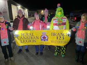 Members of the Waterford Legion prepare for the start of the Waterford Santa Claus Parade on Saturday night.  SIMCOE REFORM