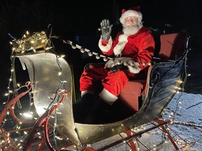 Santa awaits the start of the Christmas parade in Waterford on Saturday night.  SIMCOE REFORM