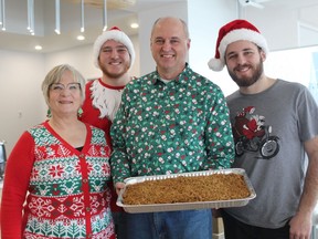 Debbie, Eli, Kelly and Jacob Heinrichs helped prepare 150 servings of apple crisp for dessert at the Community Christmas Day Dinner hosted by Church Out Serving in Simcoe.  MICHAEL RUBY