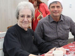 Barbara Rankin of Simcoe was among more than 100 guests expected to enjoy a Christmas dinner prepared by volunteers and hosted by Church Out Serving in Simcoe.  She was welcomed by Eric Haverkamp of Church Out Serving.  MICHAEL RUBY