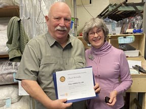 Chuck McInally, left, owner of Peerless Cleaners, was presented recently with a Paul Harris Fellow award for his support of the Rotary Club of Norfolk Sunrise Coats for Kids program. The award was presented by Bettyann Carty on behalf of the Rotary Club. CONTRIBUTED PHOTO