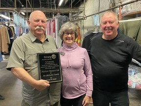 The Rotary Club of Norfolk Sunrise recently recognized Peerless Cleaners for its assistance with the club's annual Coats for Kids program.  Club member Bettyann Carty, center, presented the plaque to Peerless representatives Chuck McInally, left, and Frank McInally.  CONTRIBUTED PHOTO