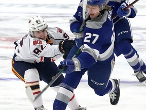 Quentin Musty, right, of the Sudbury Wolves, is checked by Roenick Jodoin, of the Barrie Colts, during OHL action at the Sudbury Community Arena in Sudbury, Ont. on Tuesday January 25, 2022. Musty's recent seven-point outing landed the former number 1 overall pick in the OHL draft in the same company as folks like Hector Marini and Ron Duguay, Norm Milley and Mike Fisher, Randy Pascal notes. John Lappa/Sudbury Star/Postmedia Network