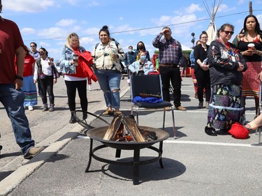 A crowd looks on at a ceremony at the unveiling of the Red Dress Art Reveal at the N'Swakamok Native Friendship Centre in Sudbury, Ont. on Thursday May 5, 2022. The event was held on the National Day of Awareness for Missing and Murdered Indigenous Women, Girls and Two-Spirit people. The art was created by Kathryn Corbiere, of One Kwe Modern Fabrications, and commissioned through the Looking Ahead to Build the Spirit of Our Women Learning to Live Free from Violence project in collaboration with the N'Swakamok Native Friendship Centre. John Lappa/Sudbury Star/Postmedia Network