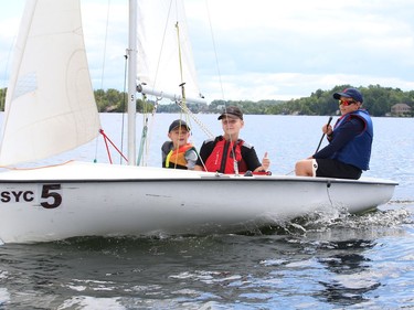 Jaxson Andryechen, left, Tristan Geroux and Liam McMahon take part in a sailing program for kids at the Sudbury Yacht Club in Sudbury, Ont. on Monday July 25, 2022. John Lappa/Sudbury Star/Postmedia Network