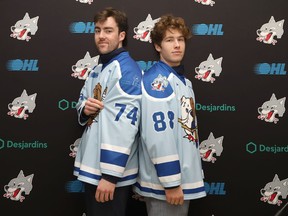 Jacob Holmes, left, and David Goyette, of the Sudbury Wolves, model the limited edition Shoresy Sudbury Blueberry Bulldogs themed jersey at a Wolves media conference on Tuesday December 6, 2022. John Lappa/Sudbury Star/Postmedia Network