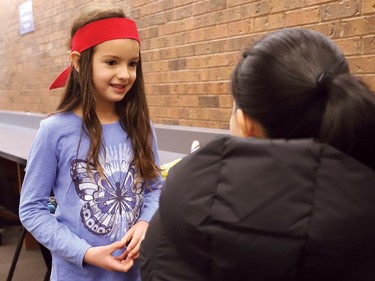 Kindness Ninja Ruhi Hosseini, 6, of Larchwood Public School in Dowling, visits with Cambrian College student Huyen Pham to spread kindness at the campus in Sudbury, Ont. on Wednesday December 7, 2022. More than 40 Kindness Ninjas from junior kindergarten to Grade 2 at Larchwood Public School, visited with Cambrian students studying for exams to spread kindness and cheer during a stressful time for college students. John Lappa/Sudbury Star/Postmedia Network