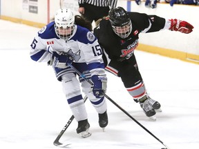 Izabel Courville, left, of the Sudbury Lady Wolves, breaks past a defender during U18 B division action against the Kapuskasing Jaguars at the annual Snowflake Challenge at the Gerry McCrory Countryside Sports Complex in Sudbury, Ont. on Friday December 9, 2022. John Lappa/Sudbury Star/Postmedia Network