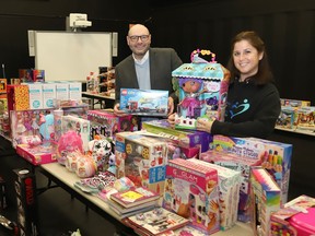 Marc Despatie, director of communications at College Boreal, and Lynne Ethier, manager of fundraising and community engagement at Our Children, Our Future, display some of the hundreds of toys that have been collected for Our Children, Our Future's Christmas toy drive at the college in Sudbury, Ont. on Friday December 9, 2022. College Boreal stepped up and provided a space for the toys to be stored, organized and distributed. The toys will be distributed to hundreds of families shortly. John Lappa/Sudbury Star/Postmedia Network