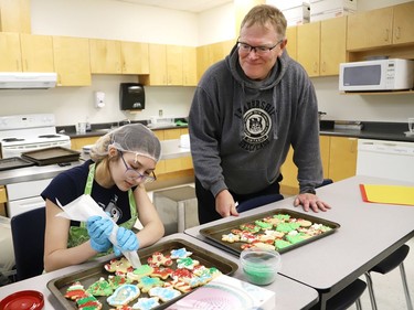 Teacher Braden MacKinnon, founder and organizer of the 15th annual holiday feast at Sudbury Secondary School, looks on as Stevie Wikiruk makes Christmas cookies for the feast at the high school in Sudbury, Ont. on Wednesday December 14, 2022. The dinner is being held at Sudbury Secondary School on Dec. 15. About 700 staff and students from the high school, as well as Grade 7 and 8 students from Lansdowne Public School and Princess Anne Public School will be chowing down on turkey, stuffing, cranberry sauce, potatoes, coleslaw, buns and ice cream. The feast includes 500 pounds of turkey, 300 pounds of potatoes and 150 pounds of vegetables, thanks to support from corporate sponsors. John Lappa/Sudbury Star/Postmedia Network

Some 800 turkey dinners will be served at Sudbury Secondary School during the annual holiday feast on Thursday, December 15th Ð with Grade 7 and 8Õs from School joining the celebration.