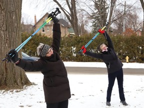 Marion Harvey Hannah, left, leads members of the Urban Poling Group in cool down exercises at Bell Park in Sudbury, Ont. on Thursday December 15, 2022. The group meets on Thursdays to take part in urban poling. John Lappa/Sudbury Star/Postmedia Network