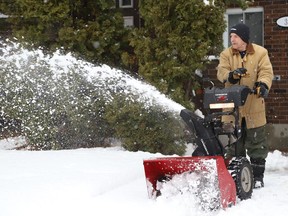 Gilles Pilon clears snow off his driveway in Greater Sudbury, Ont. on Friday December 16, 2022. Environment Canada said Greater Sudbury can expect some flurries with a high of -2 C and a wind chill near -6 C. John Lappa/Sudbury Star/Postmedia Network