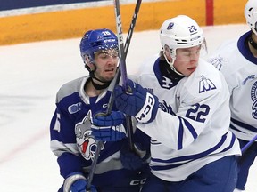 Nick DeGrazia, left, of the Sudbury Wolves, is closely checked by Kasper Larsen, of the Mississauga Steelheads, during OHL action at the Sudbury Community Arena in Sudbury, Ont. on Friday December 16, 2022. John Lappa/Sudbury Star/Postmedia Network