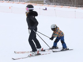 Katherine Wilson has her son, Simon, 5, in tow as they head to the ski lift at Adanac Ski Hill in Sudbury, Ont. on Monday December 19, 2022. Adanac is now open for the season. Hours of operation, fees and up-to-date hill conditions are available at www.greatersudbury.ca/play/ski-hills. John Lappa/Sudbury Star/Postmedia Network