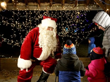 Santa Claus chats with youngsters during Light Up Kivi Park in Sudbury, Ontario on Saturday, December 3, 2022. More the 65 trees were lit up throughout the front of the park for the first time of the season. Santa stopped by for a s'more by the fire, Wonderland Storybook Walk, hot cocoa at The Wishing Tree Cafe, a Beavertail, barbecue and photoshoot. He also collected letters dropped off in the Kivi Park Santa Mailbox. Ben Leeson/The Sudbury Star/Postmedia Network