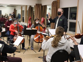 Conductor Jamie Arrowsmith leads rehearsal with the Sudbury Youth Orchestra, as they prepare for their 50th anniversary holiday concert Dec. 11. (Photo by Mia Jensen/THE SUDBURY STAR)