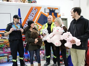 Derrick Cremin, Cochrane District EMS commander, from left, Chantal Riva, paramedic, Michael Waites, paramedic, Dilynn Belanger, EMS scheduler, and Sebastien Bedard, volunteer with CDSSAB, test out some of the toys they collected for the Christmas Angel Campaign with North Eastern Ontario Family and Children's Services. A mountain of gifts and a cheque for $4,006.45 was presented to NEOFACS by EMS on Thursday morning in the ambulance bay. 

NICOLE STOFFMAN/The Daily Press