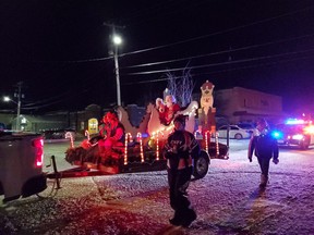 Santa and his wife waved to the crowd as they made their way through the streets of Cochrane for the annual parade.