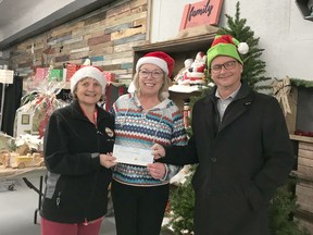 Local 175 and 633 of the United Food and Commercial Workers representatives Joy Searles and John Beaton present a check for $3 thousand to Food Bank Manager Cathy Beaton.