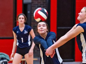 Chloe Bomberry (centre) and Josie Maclean (right) of the Assumption Lions both reach to return a serve during a high school senior girls volleyball game against the Paris Panthers on Thursday in Paris. Brian Thompson/Brantford Expositor/Postmedia Network