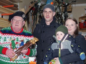 Dutton Dunwich Town Crier David Phillips, left, is shown with  Matt, Katie and Walter Routliffe. Walter is battling a form of cancer and a tree-lighting event was held to show support for the family. 
(Submitted photo)