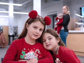 BIG AND LITTLE SISTER WAITING FOR SANTA Ashlyn Manchester and her sister Allyn make crafts while waiting for Santa to arrive at the Public Library’s North Branch Tuesday morning. Santa was a special guest at the library’s weekly Tuesday story time book reading session and read a few stories to over 60 children who registered for the event. See ssmpl.ca for other events scheduled over the holidays. BOB DAVIES