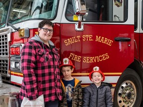 SEEING THE TRUCKS Ila Sylvestre and her sons Caleb, 6, and Michael, 3, take part in a Sault Ste. Marie Fires Services holiday fire station tour. Fire Service provided tours over the Christmas break and does school tours during the month of June, says public educator Aaron Gravelle. Children and adults were able to see the service's fleet including the pumper truck, aerial tuck and rescue truck. Approximately 200 persons registered for the eight tours that were scheduled over the holiday. BOB DAVIES