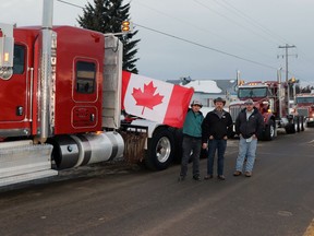 Whitecourt truckers Chris Reimer, Abraham Peters and Peter Markens joined a convoy at Western Canada Coffee Company to protest vaccine mandates for truckers crossing the U.S. border. Dozens of people gathered before long haul trucks and personal vehicles descended Hwy. 43, en route to Acheson and then the Alberta legislature.