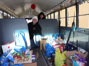 Driver Angie Droesse and Golden Arrow Manager Carla McKinney collected food donations on board a school bus near Walmart for the Stuff a Bus food drive.