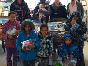 The Mwai family came to The Rock Soup Greenhouse and Food Bank to donate 100 care packs recently.