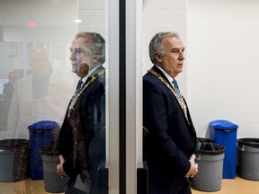 Belleville Mayor Neil Ellis is reflected in a glass window as he leads city council into a gymnasium inside the Quinte Sports and Wellness Centre on Sunday during the city's New Years Levee. ALEX FILIPE