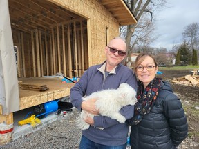 Jonathan and Linda Maracle, with family dog Lily, outside on their property where they are building villas for their resort, which they've named Moonlight on the Bay. The project was helped by a $100,000 grant through FedDev Ontario's Tourism Relief Fund. The villas are expected to open in late spring/early summer at the couple's home in Tyendinaga Mohawk Territory. (Jan Murphy/Local Journalism Initiative)
