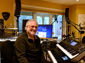 After retiring from a 35-year career as a doctor, 32 of which he spent working in Mitchell, Mark Diotallevi recently released four songs inspired in part by his experiences with his patients. Pictured, Diotellevi sits in his music studio at his home in Stratford. (Galen Simmons/The Beacon Herald)