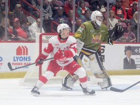 Soo Greyhounds forward  Justin Cloutier gets in front of North Bay Battalion golatender Charlie Robertson in OHL action earlier this season. Cloutier assisted on ark Duarte's goal as the Hounds lost 7-4 to North Bay on Thursday night in North Bay.