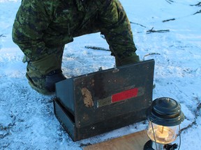 Gunner Ethan Low, a member of the Army Reserves based at the 56th Field Artillery Regiment, Royal Canadian Artillery in Brantford, lights a stove and lantern as part of winter indoctrination training on Saturday, Jan.  14.