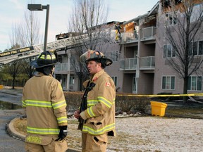From right, Curtis Lamberts, a captain with the Sarnia fire department, and acting captain Eric Morris discuss the blaze at Fairwinds Lodge retirement home on Monday. (Terry Bridge/Sarnia Observer)
