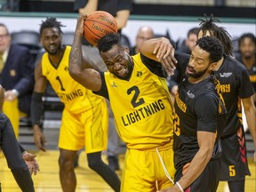 Cameron Lard (2) of the London Lightning tries to corral a loose ball while battling Evan Harris (22) of the Sudbury Five at Budweiser Gardens in London, Ont. on Friday January 20, 2023.