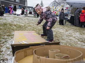 Six-year-old Shaelyn throws a ball at down a cardboard Skee-Ball game during Saturday's Winterfest in Picton, Ontario. ALEX FILIPE