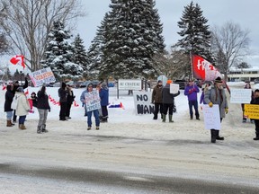 Demonstrators gather outside of Au Chateau in Sturgeon Falls to demand the home's board revise its visitation policy.