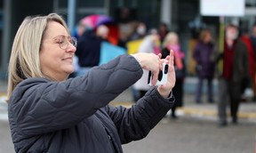 Susan Chamberlain, owner of The Book Keeper in Sarnia, records a video of a rally called All You Need Is Love ahead of a Drag Queen Story Time event being held there.  Terry Bridge/Sarnia Observer/Postmedia Network